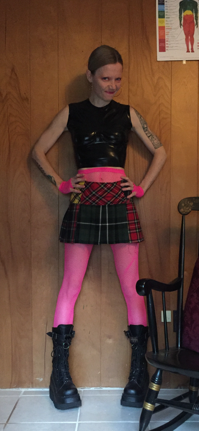 Gretchen Astro Turner standing indoors wearing a bold stylish outfit”
